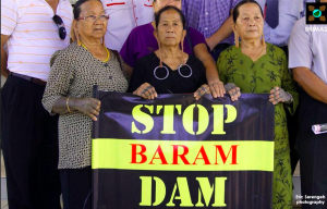 Women stand at the forefront of a protest against the Baram dam at Miri High Court. 