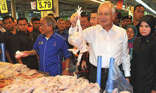 Price of chickens? Prime Minister Najib Razak (son of an ex-Prime Minister) chooses to focus on a domestic PR stunt despite being centre stage of a major world crisis.