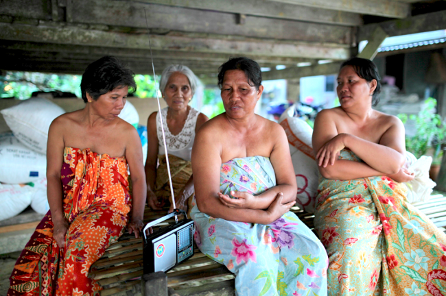 Threatened by logging gangsters - these women from Melekin listen to a report on their plight on RFS