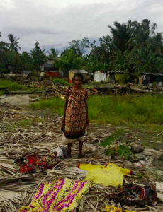 Lina Gawai from Bumbu, PNG stands where her home used to be. 