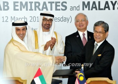 Khadem (left) shakes hands on one of several billion dollar deals with 1MDB