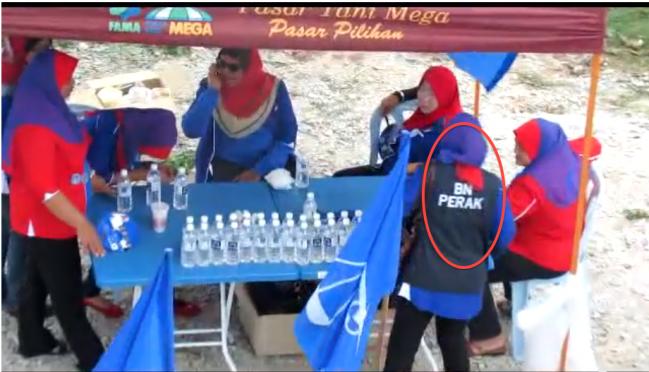 Sequence showing money being handed out to voters by BN stall outside polling station in Perak