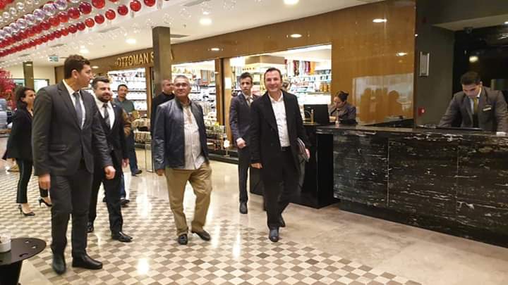 IGP Fuzi leads the way through Istanbul's shopping centre, apparently between intensive courses