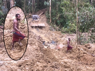 PNG workers slide barefoot in the mud around dangerous tools, whilst Malaysian managers drive in protected cabs in protective gear