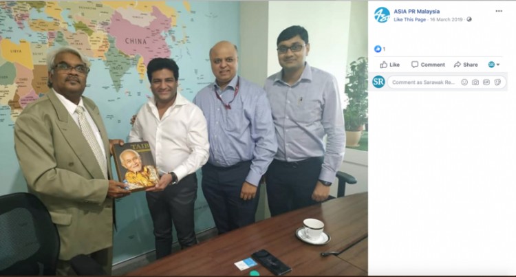 Siva Kumar G presenting a copy of his Taib hagiography to his new friends at Osho mining back in March 2019