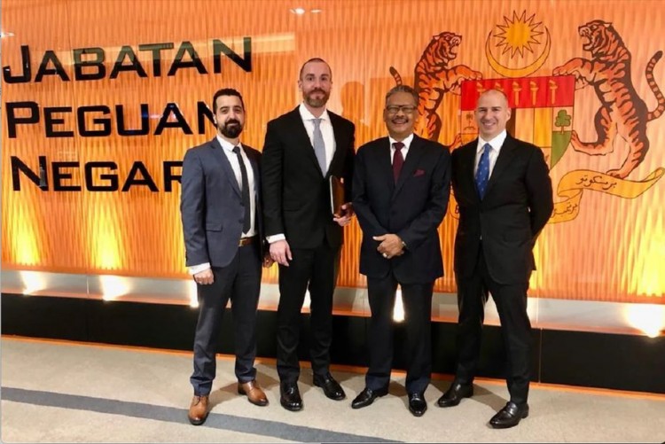 Robin Rathmell (2nd left) poses next to Apandi Ali at the Attorney General's Chambers in KL in May